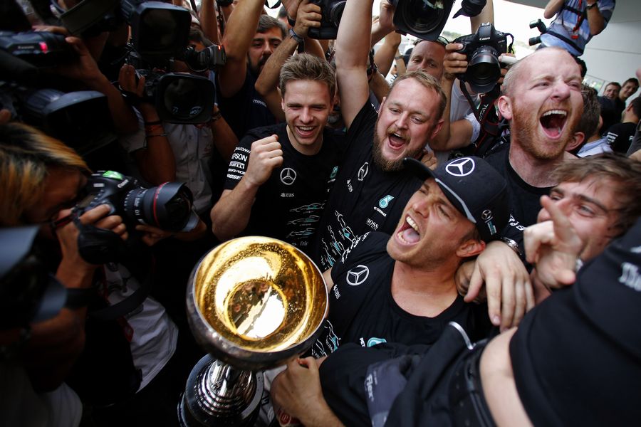 Nico Rosberg celebrates the constructors championship with the team and the trophy
