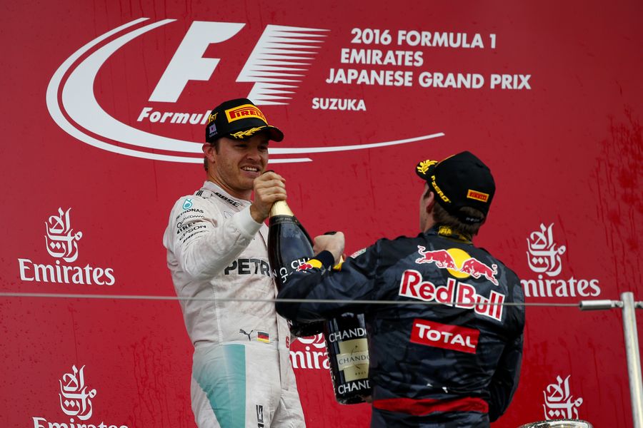 Nico Rosberg and Max Verstappen celebrate on the podium with the champagne