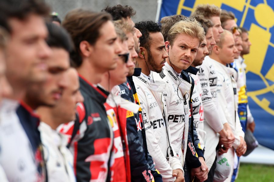 Drivers observe the National Anthem on the grid