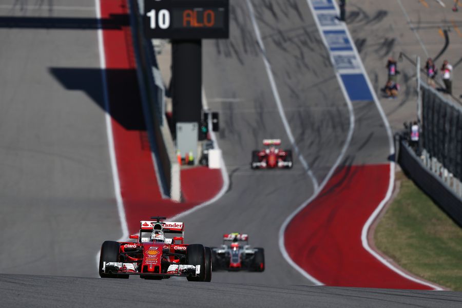 Sebastian Vettel  crests a hill in the Ferrari