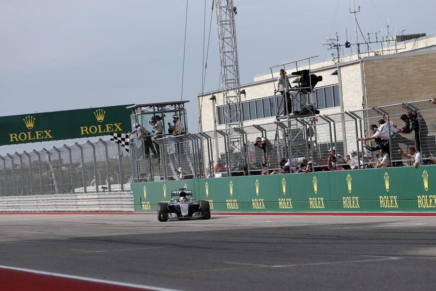 Lewis Hamilton crosses the line to take the chequered flag