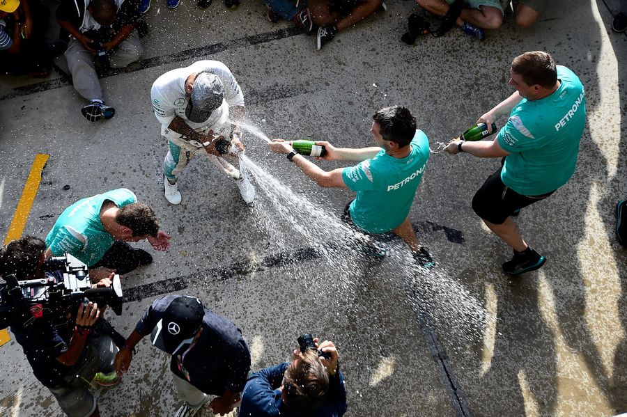 Lewis Hamilton celebrates with the team and the champagne