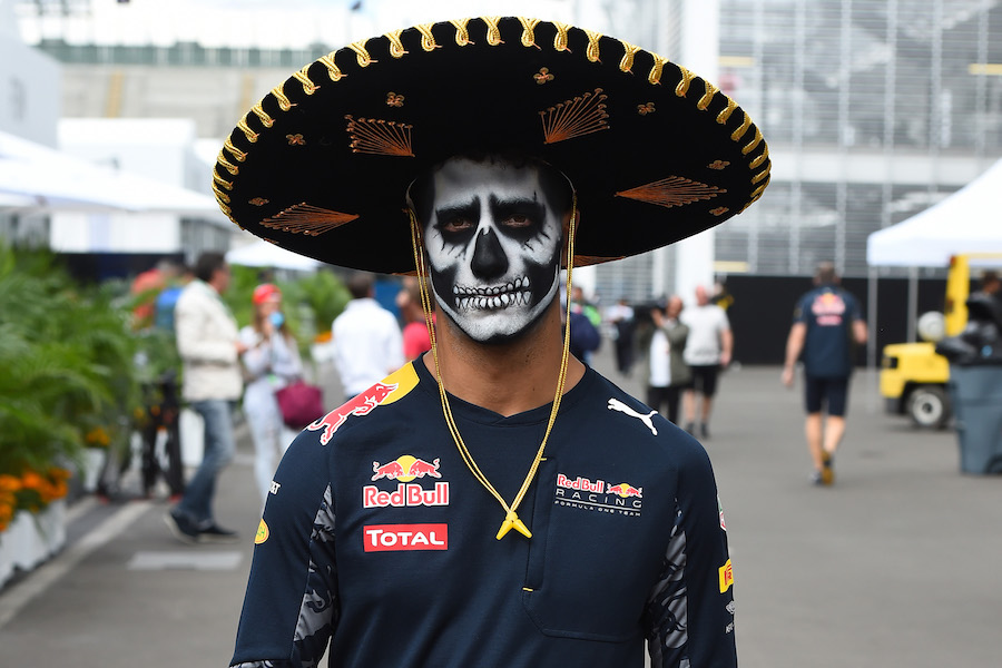 Daniel Ricciardo walks through the paddock with sombrero and face paint