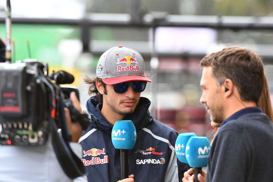 Carlos Sainz talks to media in the paddock