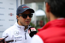 Felipe Massa speaks to media at the paddock