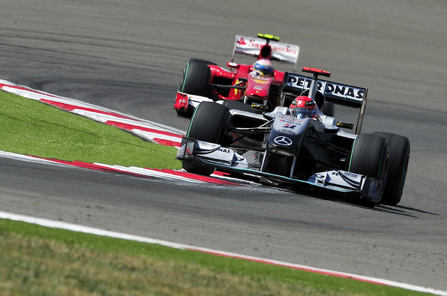 Michael Schumacher leads Fernando Alonso on a hot lap