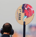 A Toro Rosso mechanic holds the lollipop sign in the pit lane
