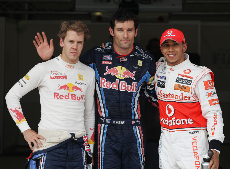 Sebastian Vettel, Mark Webber and Lewis Hamilton pose in the parc ferme after the qualifying session