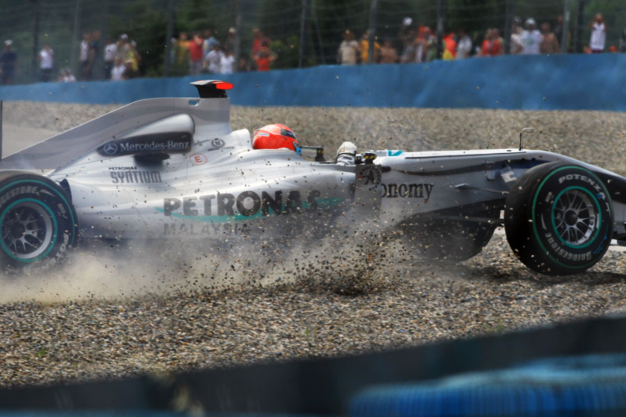 Michael Schumacher's Mercedes comes to a halt in the gravel