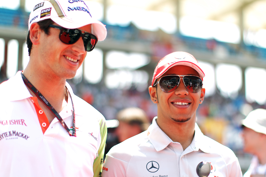 Adrian Sutil and Lewis Hamilton arrive on race day