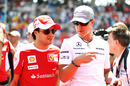 Felipe Massa and Michael Schumacher chat as they arrive for the race