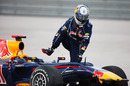 Sebastian Vettel climbs out his car after his collision with Mark Webber