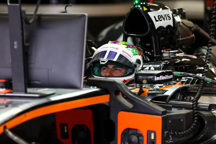 Sergio Perez looks on in the cockpit