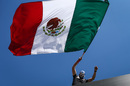 A fan waves Mexican flag
