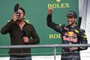 Gerard Butler drinks from the boot of Daniel Ricciardo on the podium