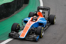 Pascal Wehrlein cranks on the steering lock in the Manor
