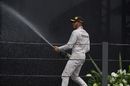 Lewis Hamilton celebrates on the podium with the champagne