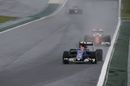 Felipe Nasr fights a position with Sebastian Vettel
