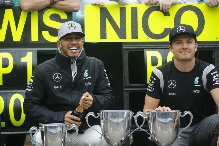 Lewis Hamilton and Nico Rosberg celebrate with the team for its 1-2 finishing