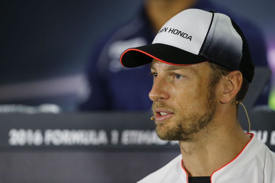 Jenson Button looks on in the press conference