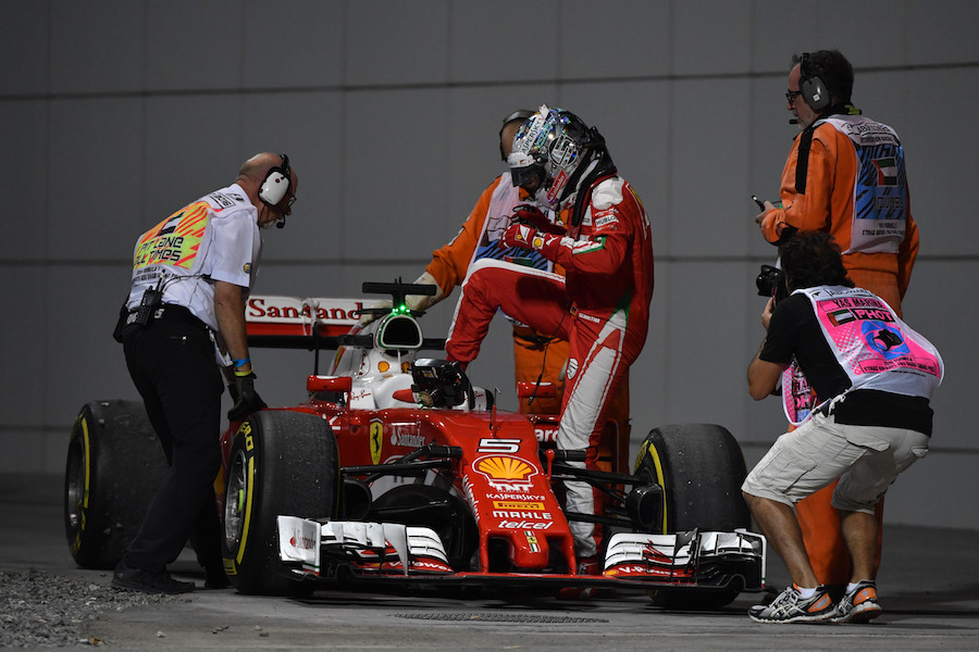 Sebastian Vettel leaves his car after stopped in FP2