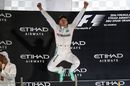Nico Rosberg celebrates on the podium with a great jump