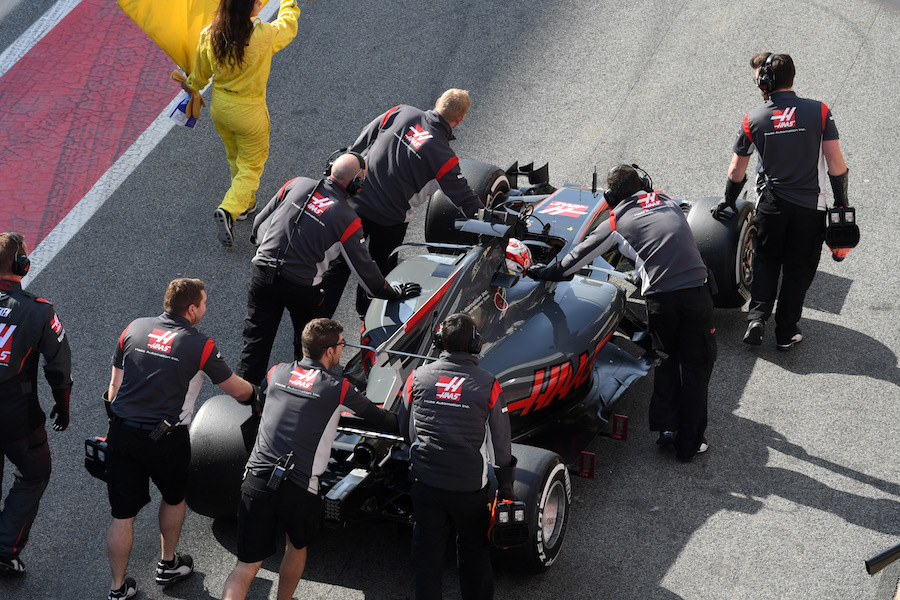 Kevin Magnussen is pushed by mechanics in pit lane