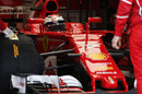Kimi Raikkonen sits in the cockpit of Ferrari