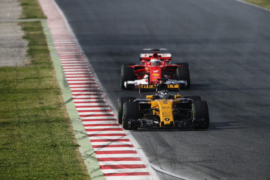 Nico Hulkenberg in the Renault leads Kimi Raikkonen in the Ferrari