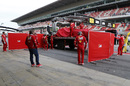 Kimi Raikkonen' Ferrari is returned to the pits and shielded with screens