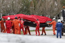 Kimi Raikkonen' Ferrari is recovered after his accident