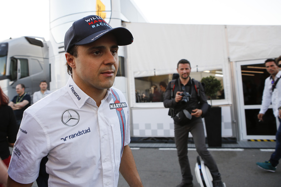 Felipe Massa walks through the paddock