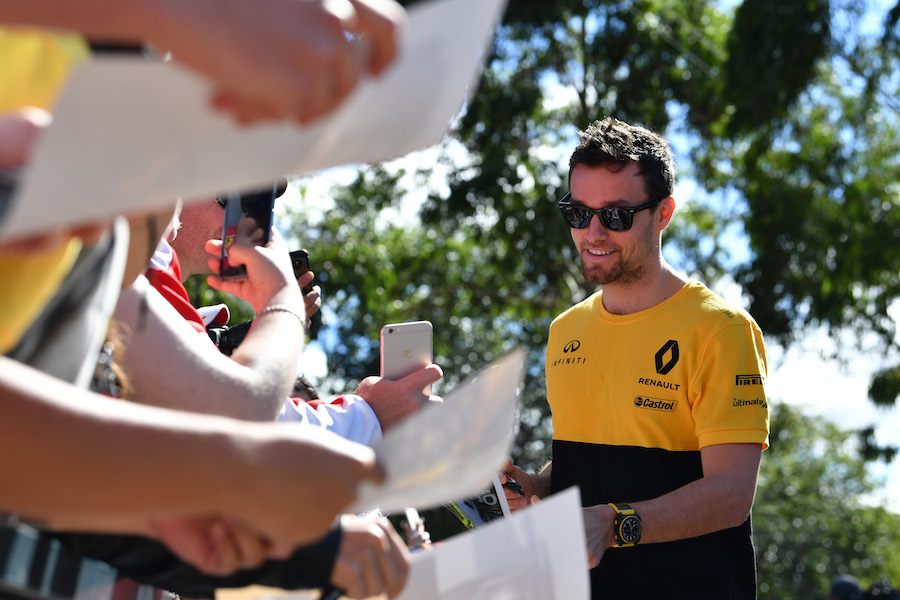 Jolyon Palmer signs autographs for the fans