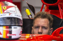 Sebastian Vettel sits in the cockpit