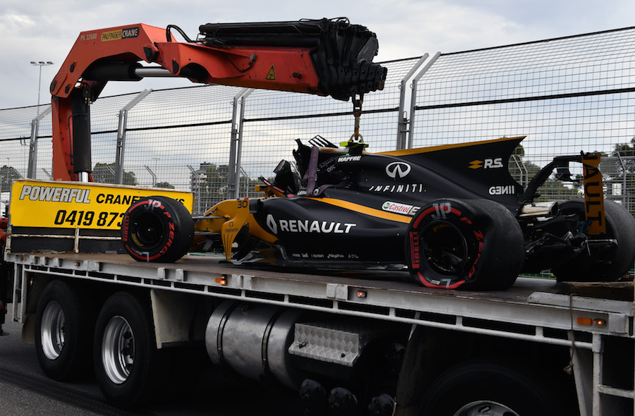 Jolyon Palmer's Renault is recovered after crashing in FP2