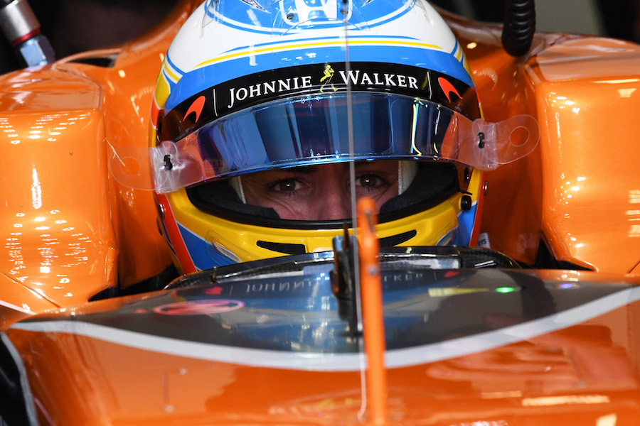 Fernando Alonso sits in the McLaren cockpit