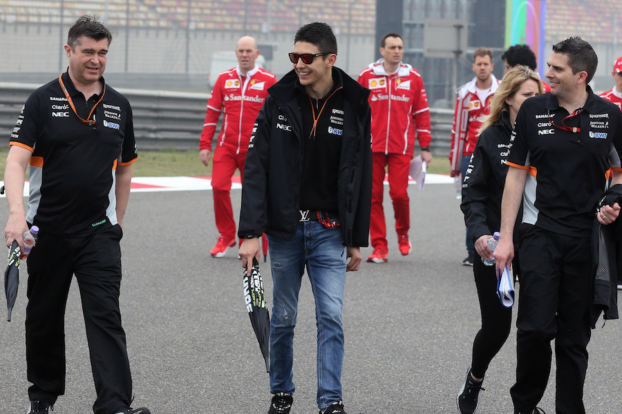 Esteban Ocon walks the track with his engineers