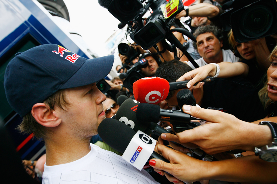 Sebastian Vettel faces the media hoards as the race goes on