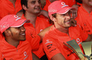 Jenson Button and Lewis Hamilton celebrate with the McLaren team