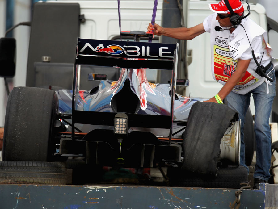 Sebastian Vettel's Red Bull is towed away