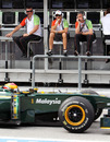 The Force India pit wall watch a Lotus head on track