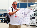 Photographer Mark Sutton poses with a signed t-shirt