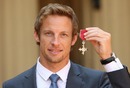 Jenson Button poses with his MBE at Buckingham Palace