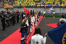 Drivers observe the National Anthem on the grid