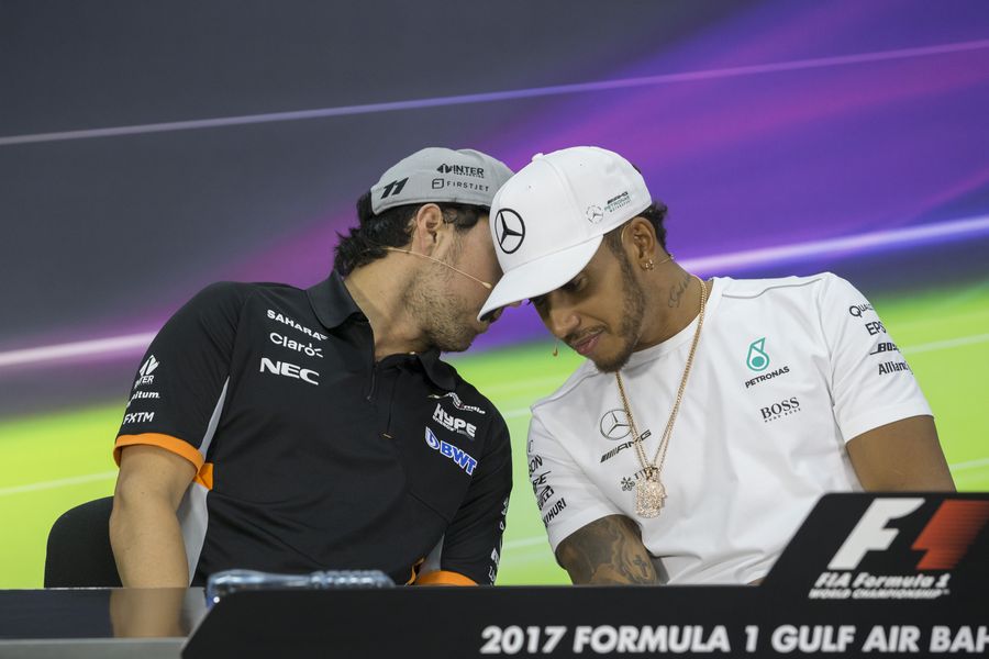 Lewis Hamilton talks with Sergio Perez in the Press Conference