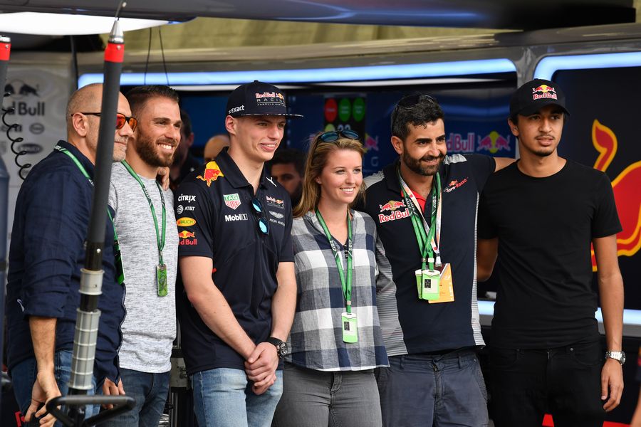 Max Verstappen takes a picture with guests