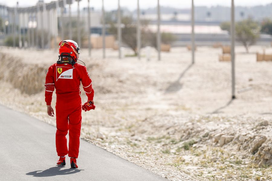 Kimi Raikkonen walks away from where he stopped on track in FP1