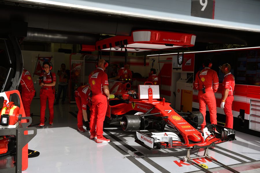 Kimi Raikkonen sits in the Ferrari cockpit in the garage