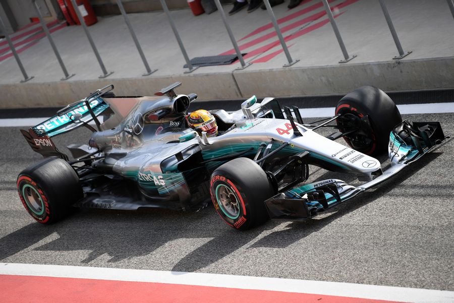 Lewis Hamilton powers down the pit lane in the Mercedes