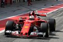 Sebastian Vettel down the pit lane in the Ferrari
